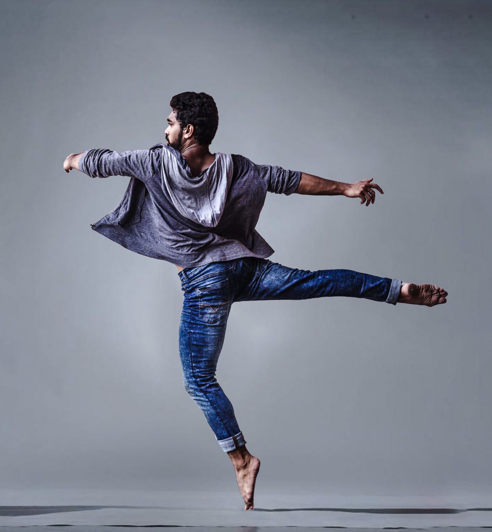 man-wearing-blue-jeans-doing-pirouette-spin-1701202